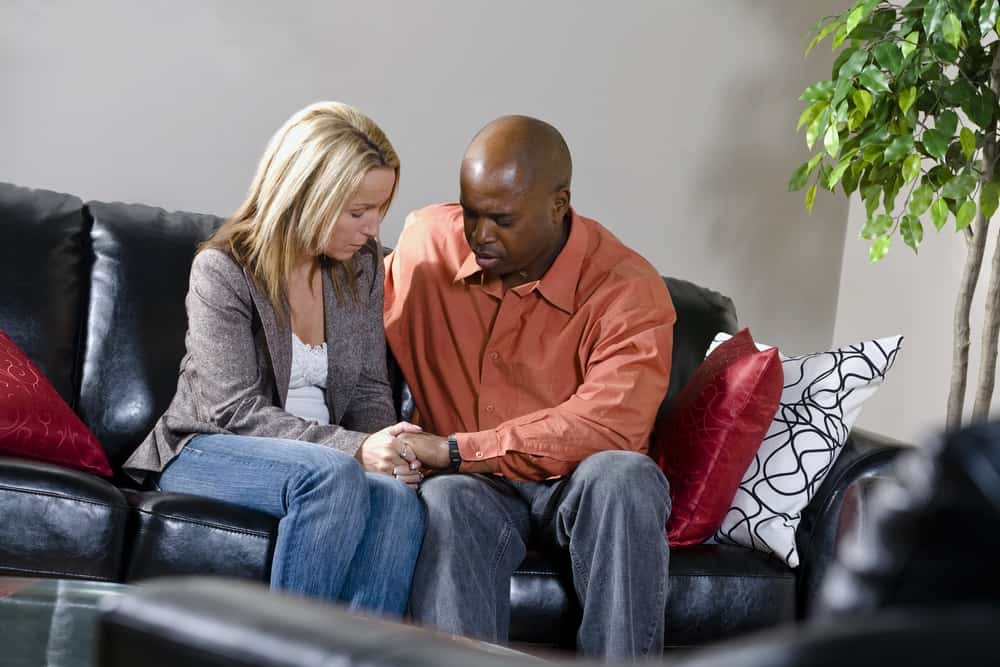 Couple praying before communicating